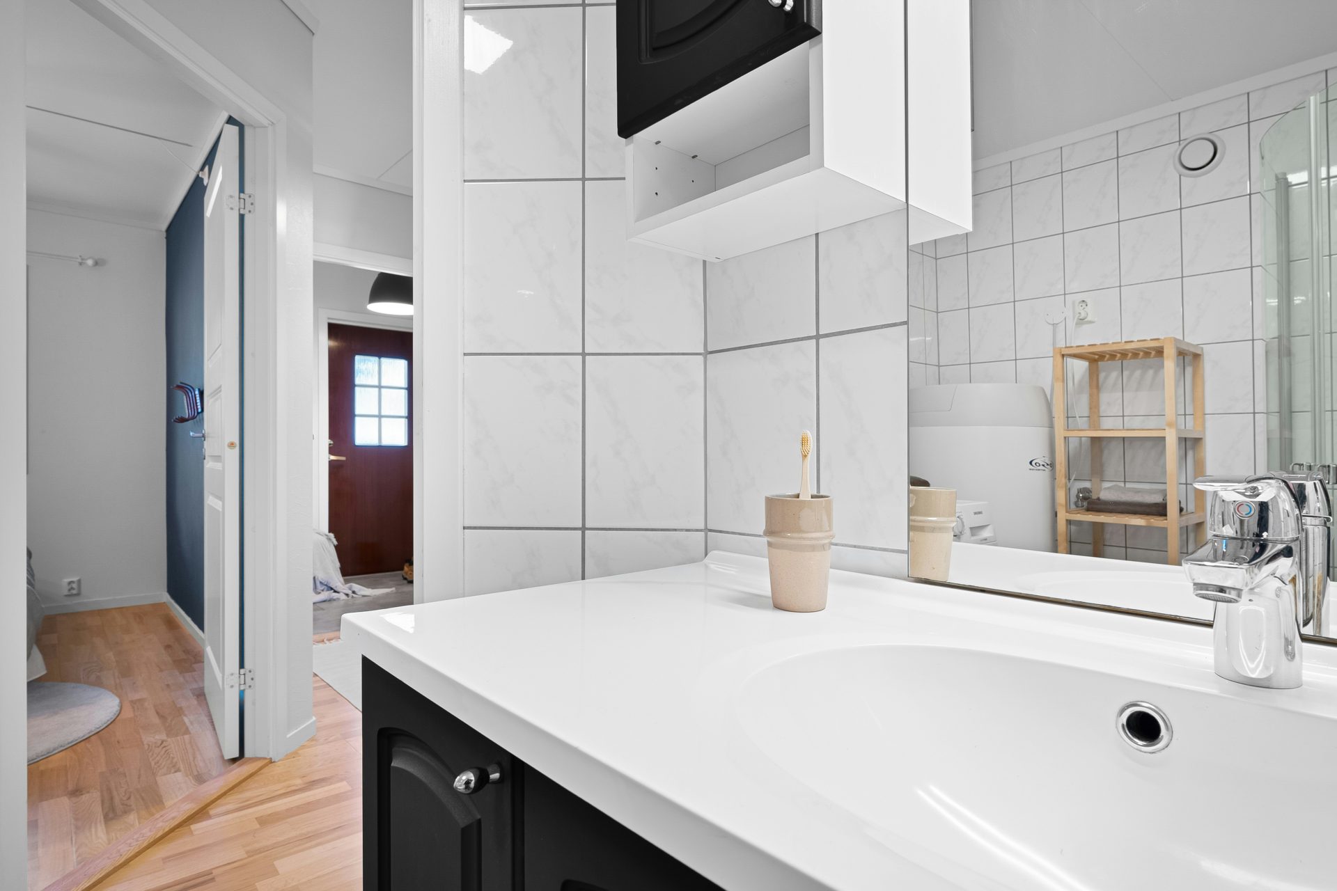 A bathroom with a sink, mirror and toilet